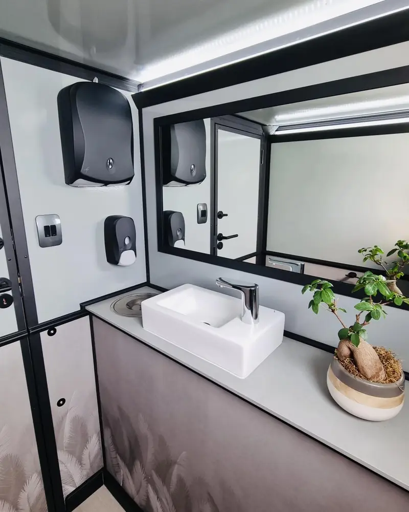 Restroom trailer sink, mirror, soap and paper towel dispensers